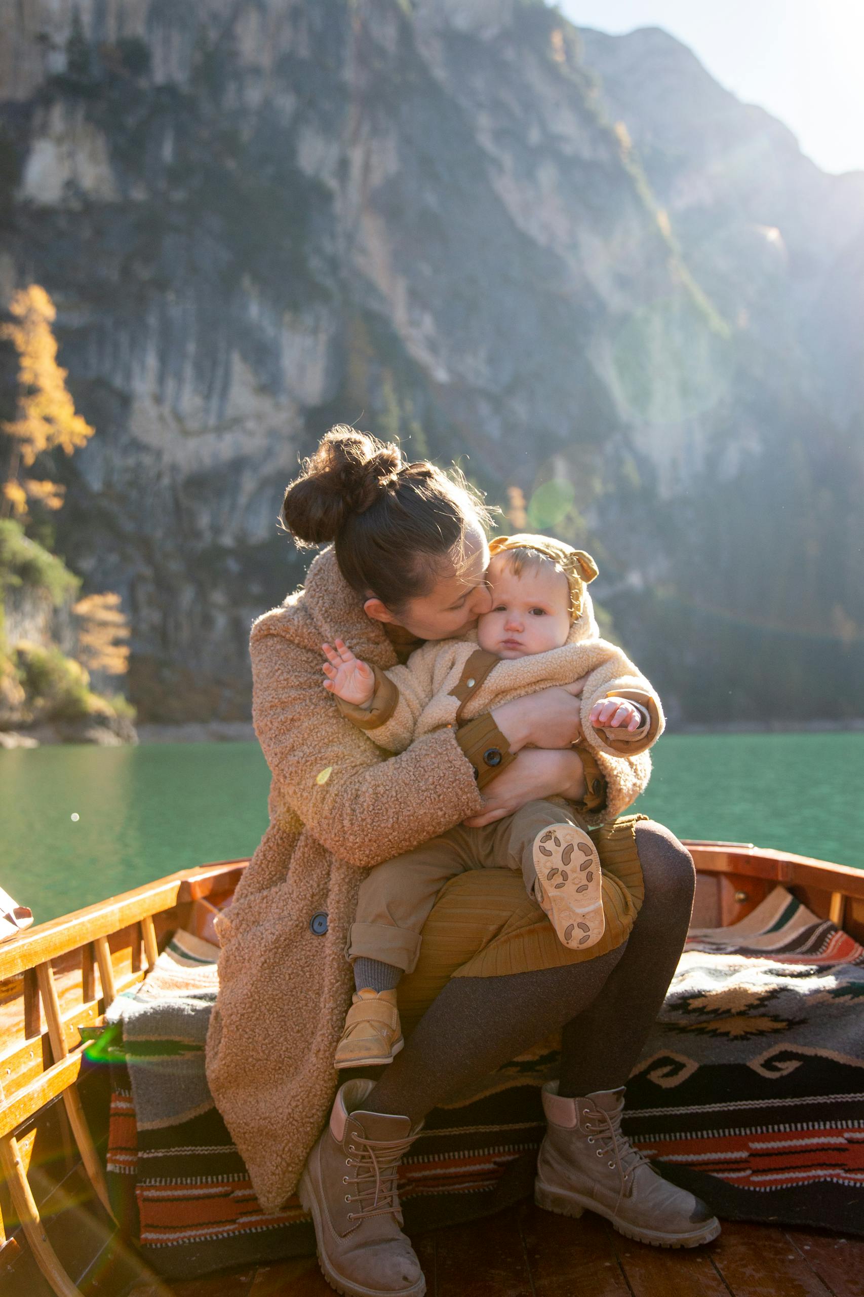 Woman in Brown Sweater Carrying Baby in Brown Sweater